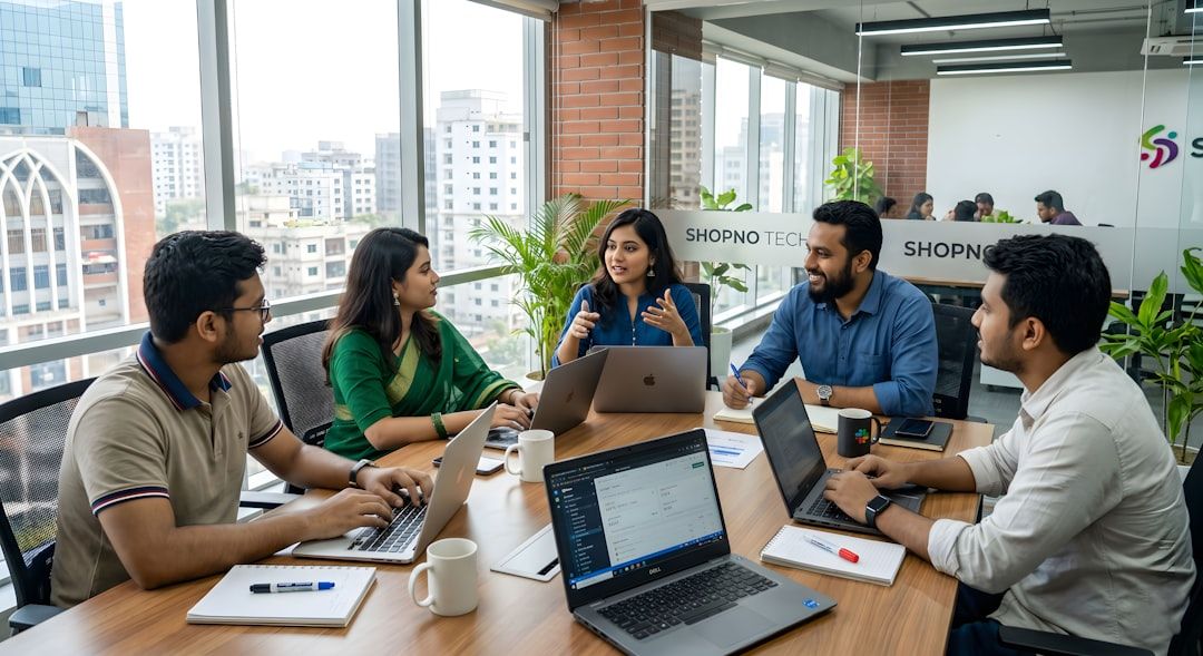 A diverse modern team collaborating with laptops around a conference table.