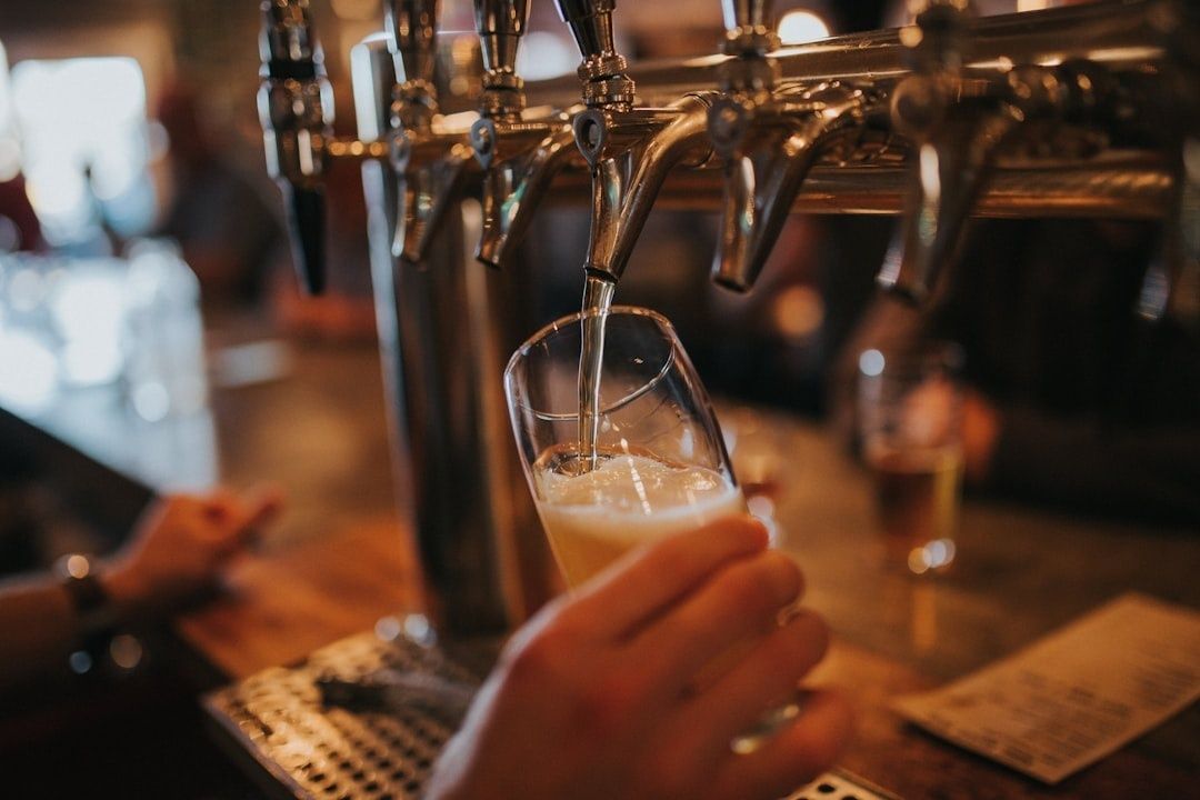 Bartender pours ale from a row of polished pub taps